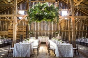 a room with tables and chairs and flowers