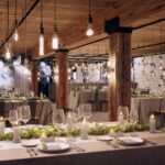 Rustic venue with hanging lights, greenery, and elegant table settings.”