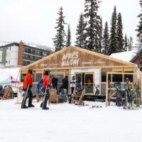 Skiers at an après-ski tent