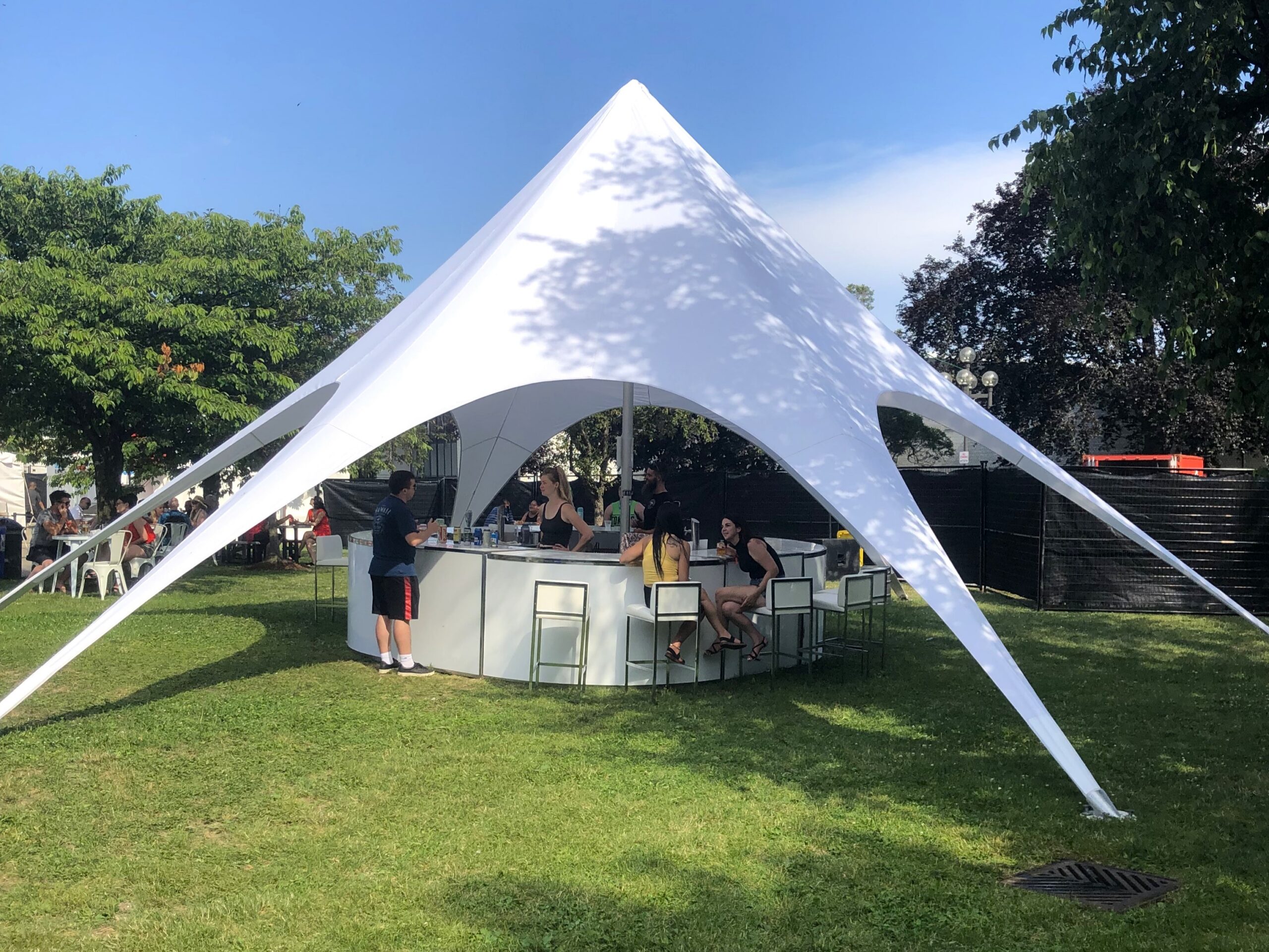 White tent over grassy gathering area