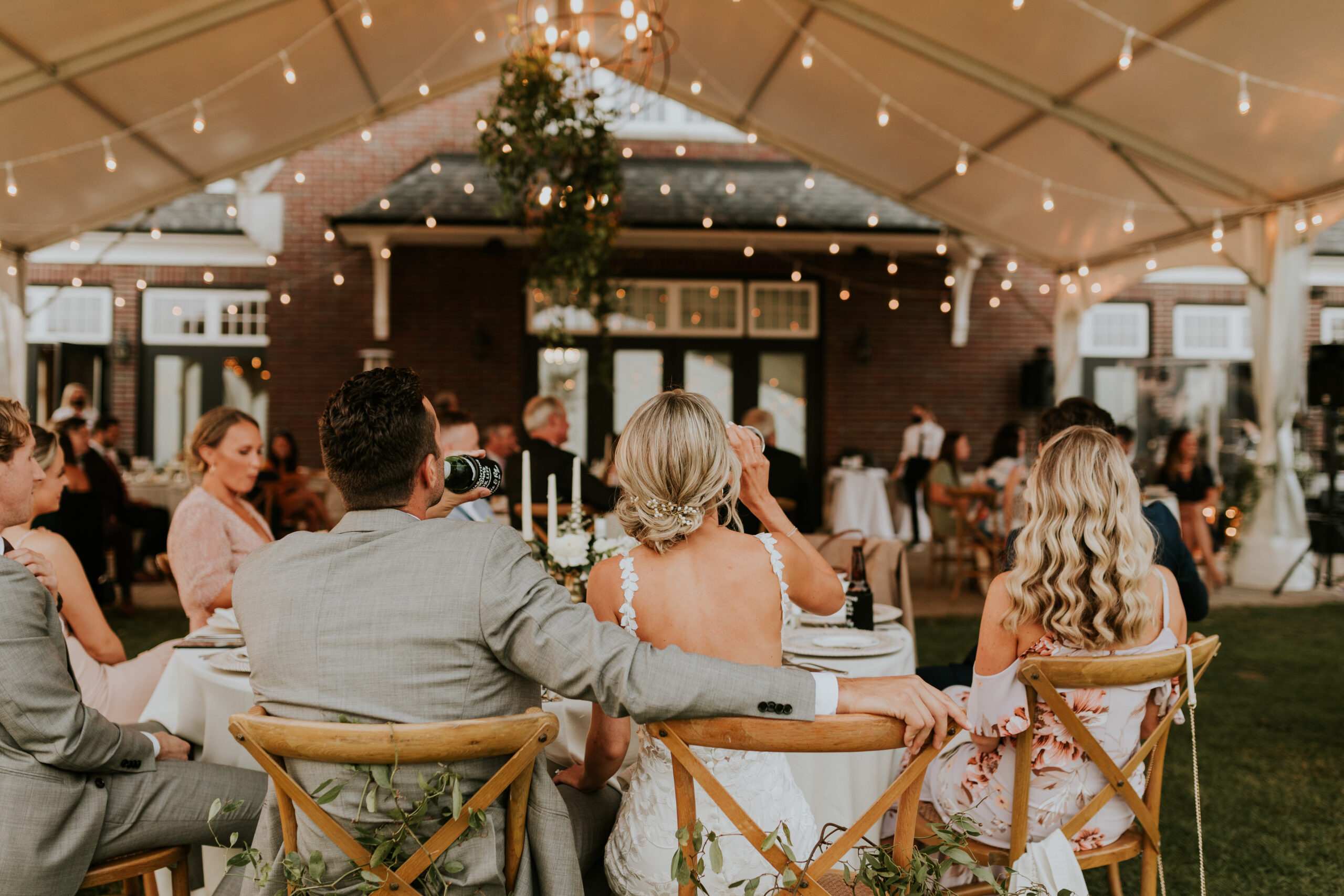 Guests enjoying a wedding reception outdoors.