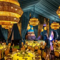 Elegant dining setup with chandeliers and Drapery rentals.