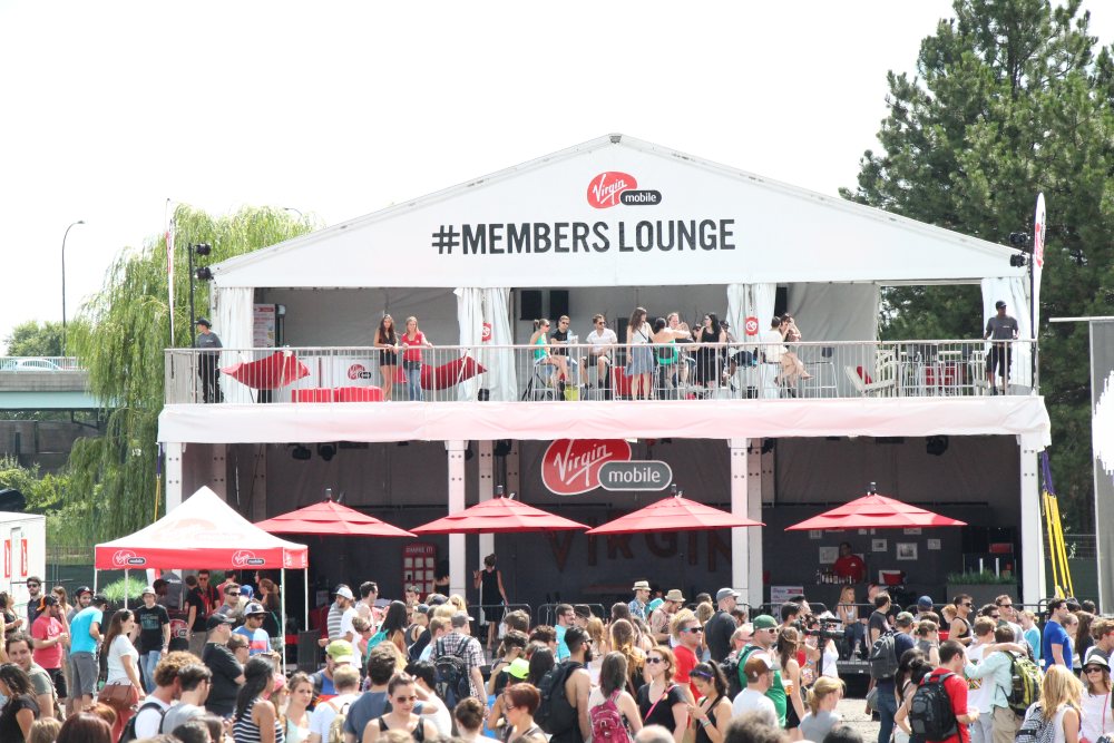 Crowd outside Virgin Mobile lounge tent with Double Decker Structure tent