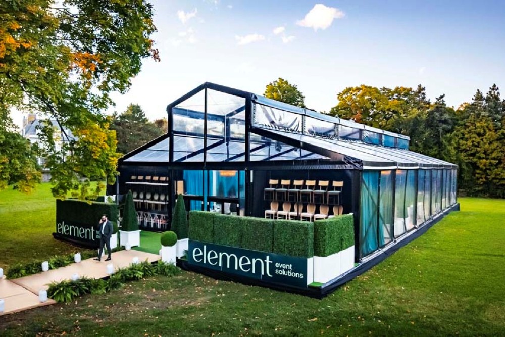 Modern glass tent in green landscape, Vista Tent